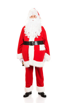 Full length Santa Claus holding a bell