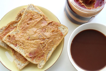 Breakfast with peanut butter sandwich and hot chocolate
