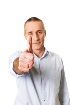 Mature man gesturing ok sign