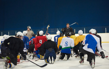 ice hockey players team meeting with trainer