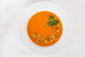 Pumpkin soup with seeds and parsley on top of the menu