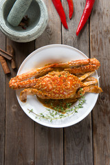 Top view cooked delicious hot and spicy sauce blue crab on white