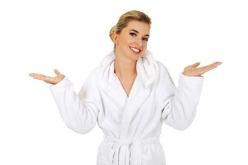 Young happy woman after bath holding somathing.