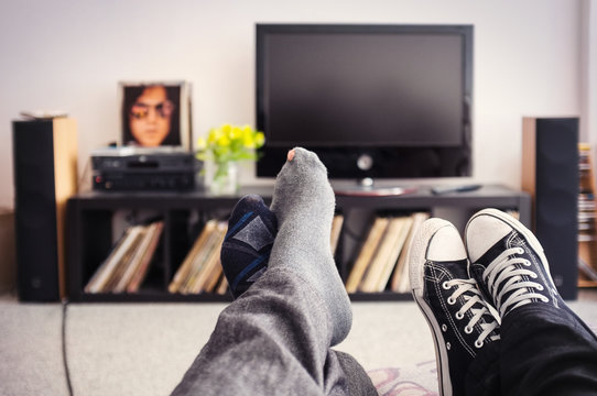 Feet of a Couple on couch in living room