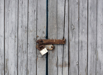 Old wooden door with padlock.