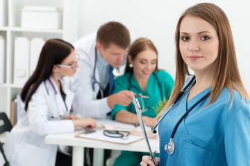 Portrait of smiling female medicine doctor holding clipping boar