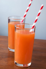 Carrot juice and slices of carrot isolated on white