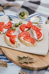 Breakfast in a forest with bruschetta with feta cheese, tomatoes and olives