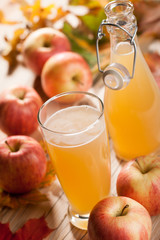Apple juice, apples and maple leaves