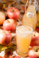Apple juice, apples and maple leaves