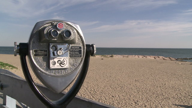 Pay per view binoculars over looking the beach