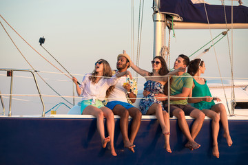 Merry company celebrates birthday on a yacht.