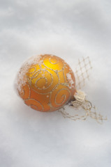 golden christmas ball on snow