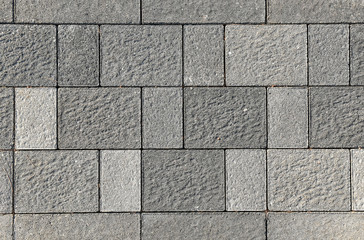 Obraz premium Concrete or cobble gray pavement slabs or stones.
