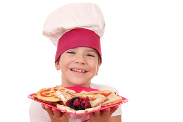 happy little girl cook with crepes portrait