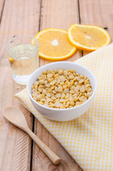 Healthy golden soil oil with a cup of raw soybean
