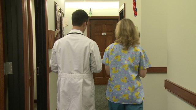 Doctor and nurse walking down hallway