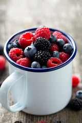 metallic mug with fresh forest berries