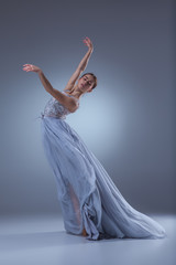 The beautiful ballerina dancing in blue long dress 