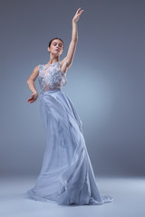 Fototapeta na wymiar The beautiful ballerina dancing in blue long dress 