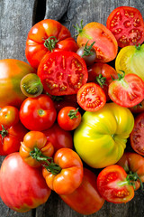assorted tomatoes on wooden surface