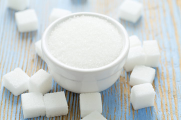 white sugar cubes on wooden surface