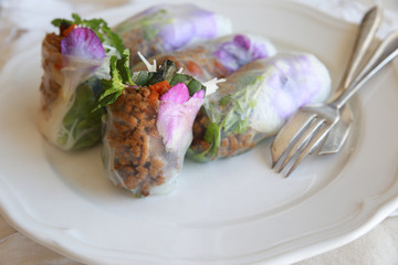 Homemade rice paper rolls with edible flowers