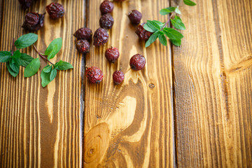 Dried rose hips on a wooden table