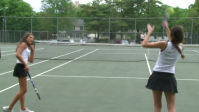 High school girls at tennis practice