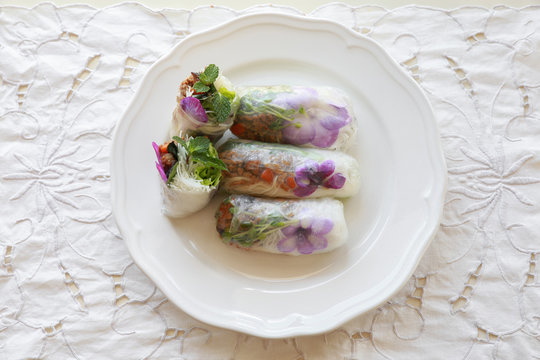 Homemade rice paper rolls with edible flowers