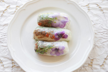 Homemade rice paper rolls with edible flowers