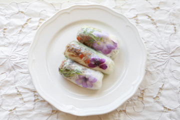 Homemade rice paper rolls with edible flowers