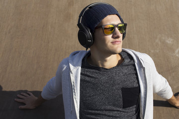 music addicted. young man listening songs with headphones