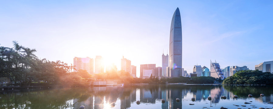 lake besides the skyscrapers under sunset