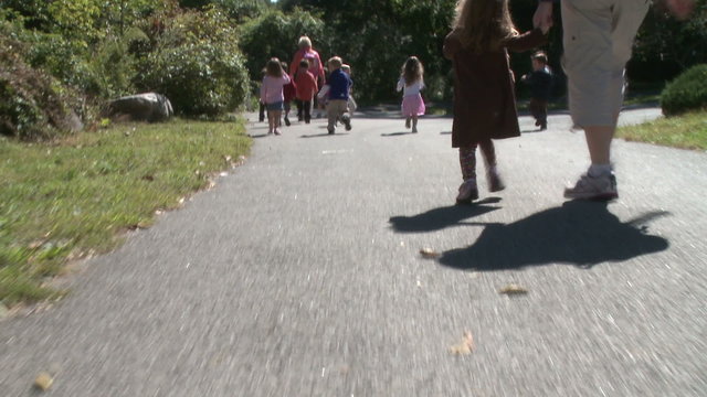 Preschool aged children walking along path