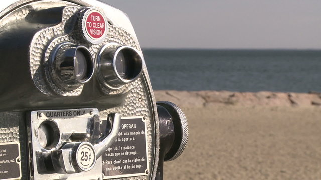 Pay per view binoculars over looking the beach
