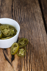 Jalapenos on wooden background
