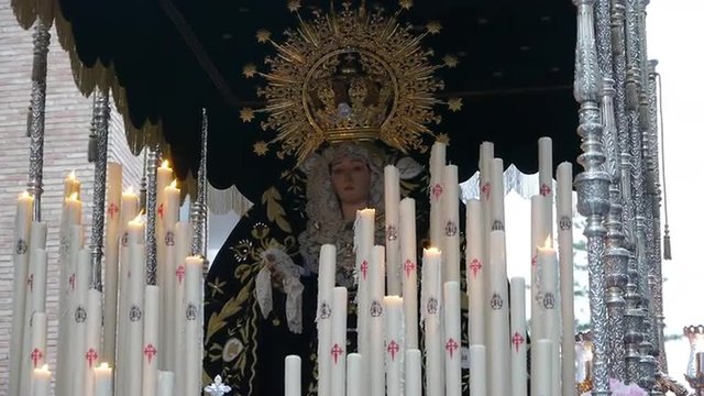  Our Lady of Sorrows in his throne with hundreds of candles, moved by the bearers   