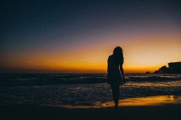 Fototapeta premium Sea beach girl silhouette, sunset