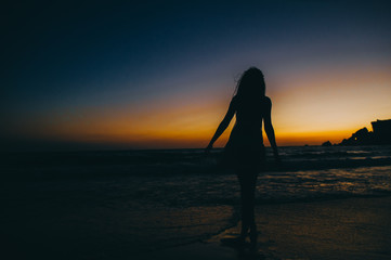 Sea beach girl silhouette, sunset