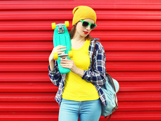 Fashion portrait of stylish girl in sunglasses and colorful clot