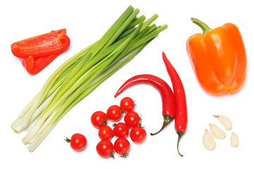 Onions, garlic, tomatoes, red bell pepper on a white background.