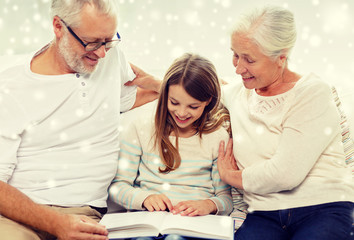 smiling family with book at home