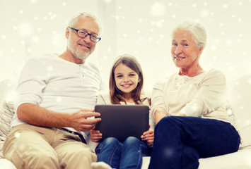 smiling family with tablet pc at home