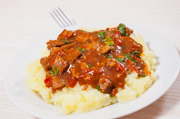 meat in sauce with mashed potatoes