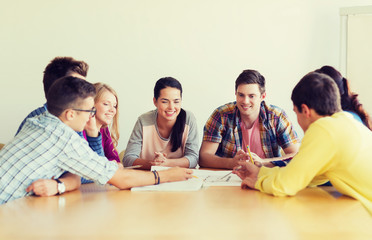 group of smiling students with blueprint