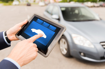 close up of male hands with car icon on tablet pc