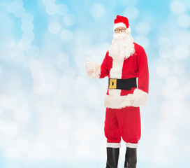 man in costume of santa claus showing thumbs up