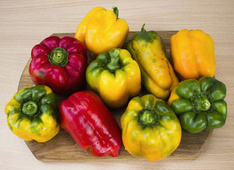 Bright, colorful, beautiful, ripe peppers on a wooden background