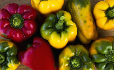 Bright, colorful, beautiful, ripe peppers on a wooden background